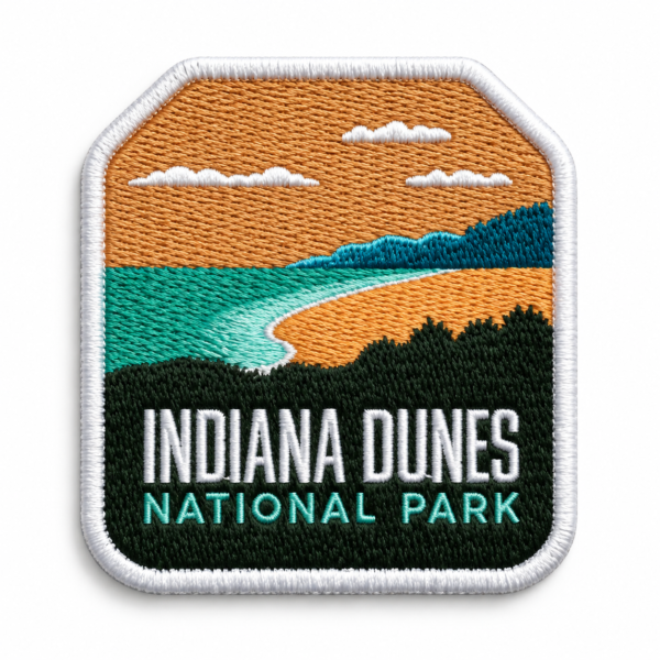 Indiana Dunes embroidered patch with orange sky, teal water, sandy shoreline, green landscape and white stitched border
