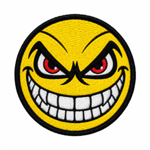 Round evil smile face embroidered patch with bright yellow background, sharp red and white eyes, large white toothy grin, bold black facial outlines, and black satin border